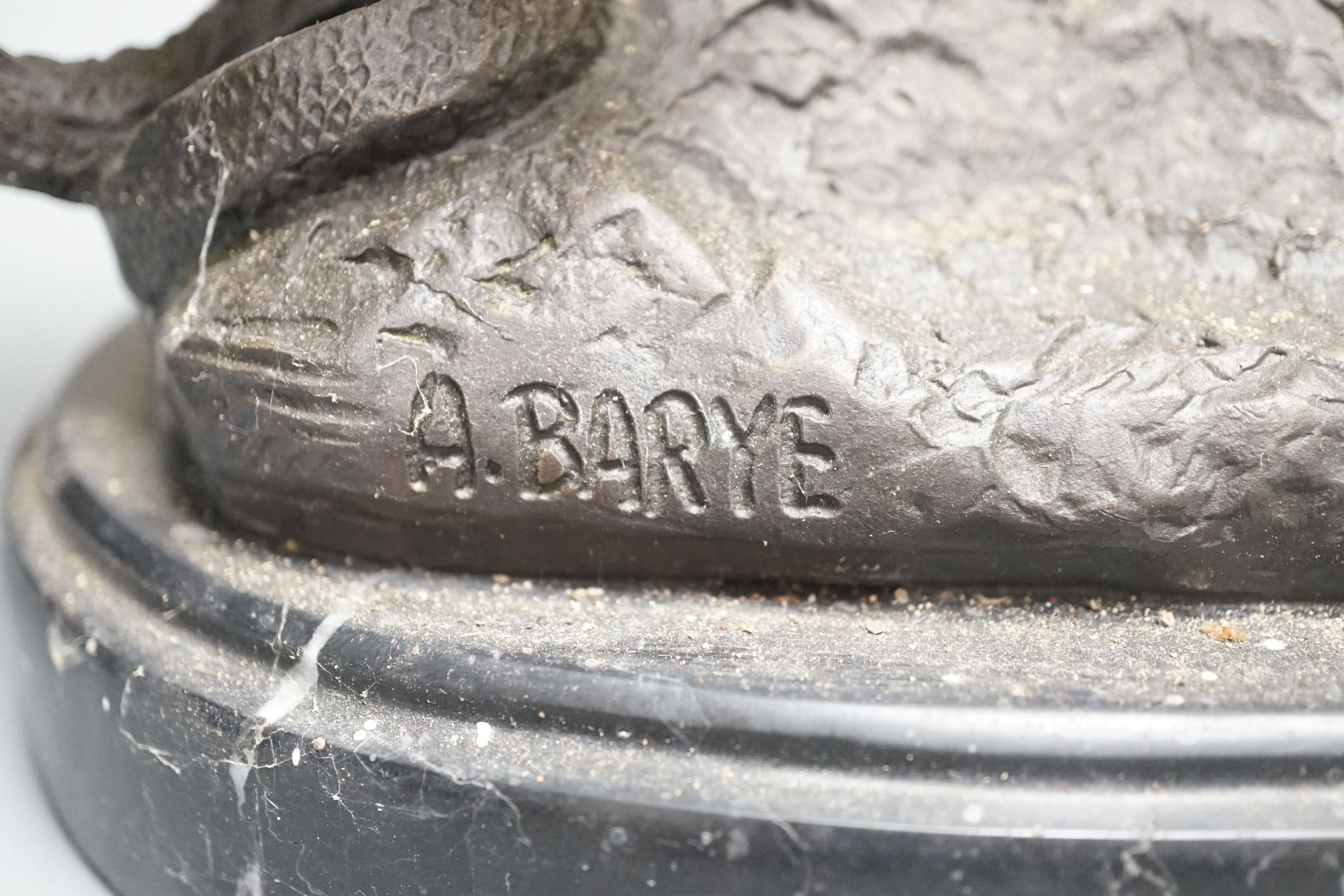 After Barye, a bronzed metal lion and serpent group, 25 cms high.